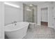 Elegant bathroom with a freestanding tub and a glass-enclosed shower at 409 Reinsman Ct, Mebane, NC 27302