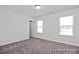 Well-lit bedroom with two windows and a door to the hallway at 409 Reinsman Ct, Mebane, NC 27302