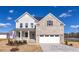 Two-story house with gray siding, brick accents, and a two-car garage at 409 Reinsman Ct, Mebane, NC 27302