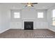 Living room with hardwood floors, fireplace, and large windows at 409 Reinsman Ct, Mebane, NC 27302