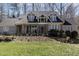 Two-story home with gray siding, stone accents, and landscaping at 52302 Fowle, Chapel Hill, NC 27517