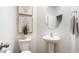 Small bathroom with pedestal sink, toilet, and oval mirror at 5512 Henley Ridge Dr # 191, Graham, NC 27253