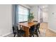 Dining area with wood table and black chairs, view of entryway at 5512 Henley Ridge Dr # 191, Graham, NC 27253