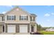 Tan two-story townhome with a two-car garage and landscaping at 5512 Henley Ridge Dr # 191, Graham, NC 27253