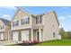 Two-story townhome with stone accents and landscaping at 5512 Henley Ridge Dr # 191, Graham, NC 27253