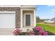 Townhome's front door with stone and landscaping at 5512 Henley Ridge Dr # 191, Graham, NC 27253