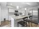 Updated kitchen boasts granite countertops, stainless steel appliances, and white cabinetry at 6000 Clare Ct, Raleigh, NC 27609