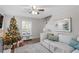 Cozy living room features a comfortable sofa, decorated Christmas tree and fireplace at 6000 Clare Ct, Raleigh, NC 27609