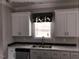 White shaker cabinets, marble countertops, and a double sink at 6016 Charlies Deadend Rd, Efland, NC 27243