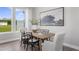 Bright dining room with a wood table, six chairs, and large windows at 6334 Lady Eliza Ln, Raleigh, NC 27610