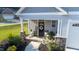 Inviting front porch with rocking chairs, welcome sign, and potted plants at 701 Cherry Tree Dr, Mebane, NC 27302