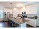 Modern kitchen with white cabinets, granite counters, and island at 701 Cherry Tree Dr, Mebane, NC 27302