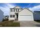 Two-story house with a white vinyl exterior, attached garage, and landscaping at 7041 Spanglers Spring Way, Raleigh, NC 27610