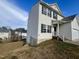 Two-story house with a white vinyl exterior, and a partial view of the backyard at 7041 Spanglers Spring Way, Raleigh, NC 27610