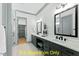 Double vanity bathroom with gray cabinets and a large mirror at 110 Broadleaf Ln, Louisburg, NC 27549