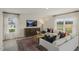 Living room with a white sofa, wood coffee table, and large windows at 113 Reagan Crest Dr, Clayton, NC 27520