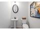 Clean powder room with pedestal sink, toilet, and framed art at 116 Knoll Way, Sanford, NC 27332