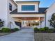 Covered parking area with two garage doors and beautiful landscaping at 1425 Sky Vista Way, Raleigh, NC 27613