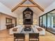 Open concept living area with high ceilings, a fireplace, and large windows at 1425 Sky Vista Way, Raleigh, NC 27613