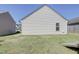 Rear view of house with vinyl siding and small window at 1732 Great Bend Dr, Durham, NC 27704