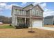 Two-story house with gray siding, white garage door, and landscaping at 188 Avery Meadows Dr, Smithfield, NC 27577