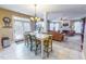 Bright dining area with table and chairs, open to living room with fireplace at 203 Barrington Overlook Dr, Durham, NC 27703