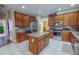 Spacious kitchen featuring wood cabinets, stainless steel appliances, and an island at 203 Barrington Overlook Dr, Durham, NC 27703