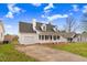 White two-story house with a gray roof, a driveway, and a grassy lawn at 2217 Maybrook Dr, Raleigh, NC 27610