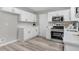 Modern kitchen featuring white cabinets, stainless steel appliances, and quartz countertops at 2217 Maybrook Dr, Raleigh, NC 27610