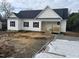 Newly constructed home with white siding, black windows, and a covered porch at 2223 Wrenn St, Burlington, NC 27215