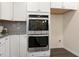 Double oven and white shaker cabinets in this spacious kitchen at 225 Sage Oak Ln, Holly Springs, NC 27540