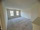 Bright bedroom with carpet flooring and two large windows at 321 Spelt Ct, Rolesville, NC 27571