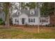Charming white house with a gray roof and manicured lawn at 421 S Morgan St, Roxboro, NC 27573