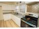 Modern kitchen with white cabinets, granite countertops, and stainless steel appliances at 421 S Morgan St, Roxboro, NC 27573