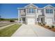 Two-story townhome with gray siding, two-car garage, and landscaping at 507 Fife Ct, Gibsonville, NC 27249
