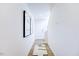 Light hallway with wood-look flooring, leading to the stairs at 507 Fife Ct, Gibsonville, NC 27249