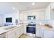 Modern kitchen with stainless steel appliances and granite countertops at 507 Fife Ct, Gibsonville, NC 27249