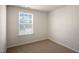 Well-lit bedroom with carpet and large window at 508 Fife Ct, Gibsonville, NC 27249