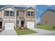 Tan two-story townhome with a double garage and landscaped front yard at 508 Fife Ct, Gibsonville, NC 27249