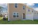 Rear view of townhouse with private patio and fenced yard at 508 Fife Ct, Gibsonville, NC 27249