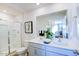 Modern bathroom with double vanity, large mirror, and walk-in shower at 509 Fife Ct, Gibsonville, NC 27249