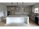 Modern kitchen featuring center island, white cabinets, and quartz countertops at 5168 Church Rd # 22, New Hill, NC 27562