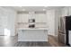 Modern kitchen with white cabinets and a large island at 532 Hanover Shore Ln, Raleigh, NC 27610