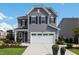 Two-story gray house with white garage door and landscaping at 601 Emerald Bay Cir, Raleigh, NC 27610