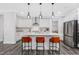 Modern kitchen with white cabinets, island with seating, and stainless steel appliances at 601 Emerald Bay Cir, Raleigh, NC 27610