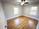 Bedroom with hardwood floors and two windows at 603 Forest Dr, Garner, NC 27529