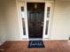 Black front door with sidelights and a welcome mat at 603 Forest Dr, Garner, NC 27529