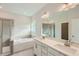 Main bathroom with double vanity, soaking tub and a separate shower at 604 Emerald Bay Cir, Raleigh, NC 27610