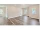 Luxury bedroom with grey wood flooring and multiple windows at 604 Emerald Bay Cir, Raleigh, NC 27610