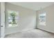 Spacious bedroom with grey carpet and two large windows at 604 Emerald Bay Cir, Raleigh, NC 27610